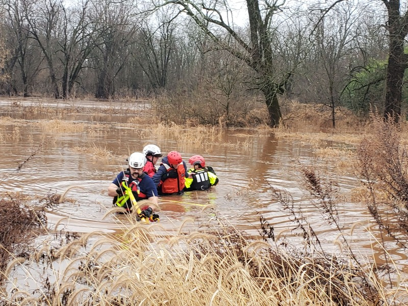 Rescue team wading through floodwaters for Predictive Drift Vectoring
